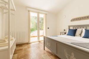 a bedroom with a large bed and a large window at Villa Stefanina - Vista mare e piscina privata vicina alla spiaggia di Cala Sinzias in Castiadas +31 photos