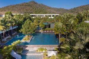 uma vista aérea de uma piscina de resort com palmeiras em Stay Wellbeing & Lifestyle Resort em Praia de Rawai