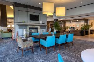 a dining room with a table and blue chairs at Hilton Garden Inn Pittsburgh/Southpointe in Canonsburg