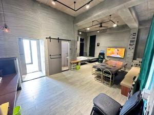 a room with a table and a television in it at 隱月民宿 in Hengchun South Gate