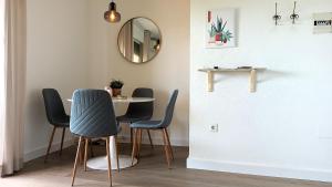 a dining room with a table and chairs and a mirror at San Fausto in Aguadulce