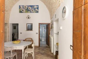 a kitchen and dining room with a table and chairs at Appartamento Vintage con Balcone by Wonderful Italy in Ostuni +28 photos