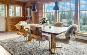 a dining room with a wooden table and chairs at Cozy Home In Lillehammer With Sauna in Lillehammer