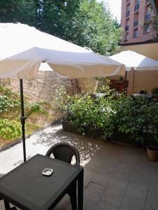 a table with an umbrella on a patio at La Corte del Sant'Orsola in Bologna