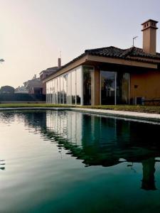 a large pool of water in front of a building at Chalet Puerto Sherry in El Puerto de Santa María