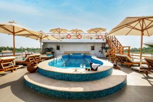 a pool on the roof of a resort with tables and chairs at M/Y Alexander The Great Nile Cruise - 4 Nights Every Monday From Luxor - 3 Nights Every Friday from Aswan in Luxor