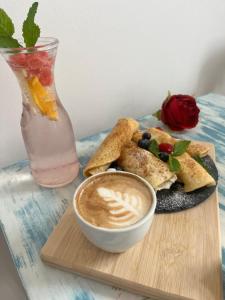 a plate of food with a cup of coffee and a drink at Apartmány v Podzámčí v blízkosti zámku Blatná in Blatná