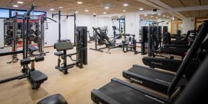 a gym with a bunch of treadmills and machines at Isla Mallorca & Spa in Palma de Mallorca