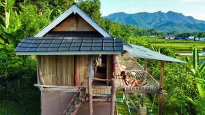 a girl sitting on a swing in a tree house at De Chicktoria Hostel in Pawenang +10 photos