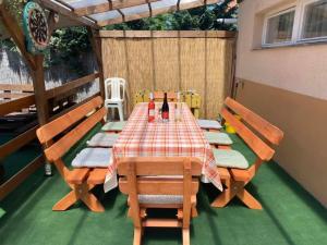 a patio with a table and chairs on a deck at PICNIC Vendégház in Bogács