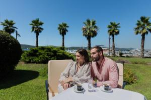 a man and a woman sitting at a table at Hotel Ilirija in Biograd na Moru