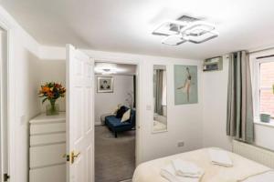 a bedroom with a bed and a ceiling fan at The Nook, Cosy 1BR in Blandford, Dorset in Blandford Forum