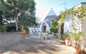 a patio with chairs and tables in a building at Trullo 1474 in Ceglie Messapica