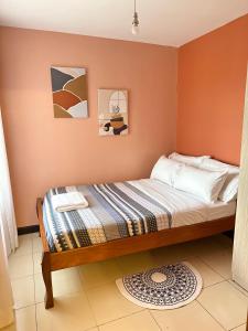 a bedroom with a bed in a room at Cozy Home Near Wilson Airport & Giraffe Center in Nairobi