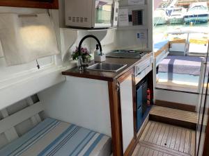 an interior view of a kitchen in a rv at Lovely wooden boat in Port forum, with AC and two bikes. in Barcelona