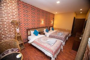 Letto o letti in una camera di Hong Si Hotel- A Home Away from Home