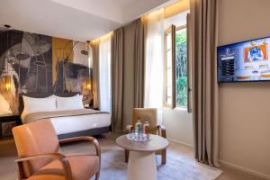 Телевізор і / або розважальний центр в Palais Ségurane Boutique Hôtel