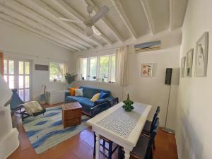 a living room with a blue couch and a table at Casa Scirocco Lipari in Lipari