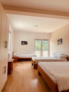 a bedroom with two beds and a window at Zlatarska kruna in Nova Varoš