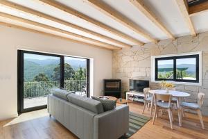 a living room with a couch and a table at Casas das Olas in Arcos de Valdevez