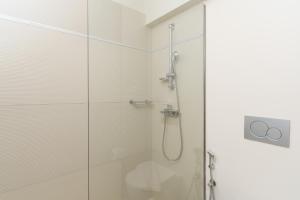 a shower with a glass door in a bathroom at Gallery Central Piraeus Port in Piraeus