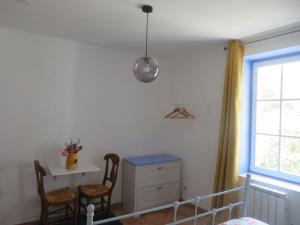 a bedroom with a bed and a desk and a window at Auberge de la petite casserole in Revest-des-Brousses +8 photos