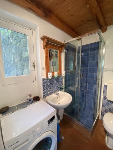 a bathroom with a washing machine and a sink at Casa Scirocco Lipari in Lipari +26 photos