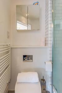 a bathroom with a toilet and a mirror at Pass the Keys Executive Penthouse 2 Bed Jewellery Quarter in Birmingham