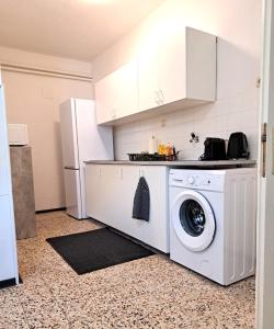a kitchen with a washing machine and a refrigerator at revLIVING Apartment Octavus Hohenwarth 3 Schlafzimmer 