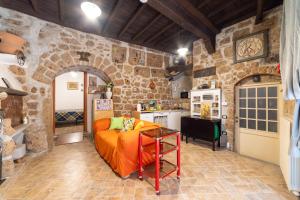 a bedroom with a bed in a stone walled room at Radici Etrusche Sutri in Sutri