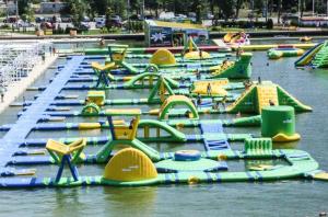 a bunch of inflatable water slides in the water at Apartament Resort in Constanţa