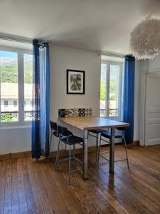 una sala da pranzo con tavolo e 2 sedie di Le cocon de la Pare- Superbe T3 plein centre a Barcelonnette