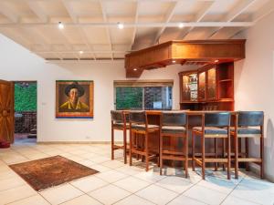 a kitchen with a bar with leather stools at The Hideaway at 88 in Ballito