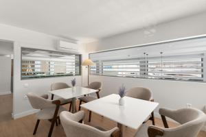 a meeting room with two tables and chairs at Gallery Central Piraeus Port in Piraeus