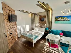 a room with a bed and a table and a desk at Апартамент Vip Vision Studio LUX in Sunny Beach