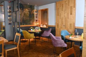a restaurant with tables and chairs and a painting on the wall at Hotel Kiekenstein in Stahle