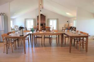 a dining room with a large wooden table and chairs at Traumhafter Vierseitenhof in Ostseenähe für Workshops, Seminare und Retreats in Pommerby