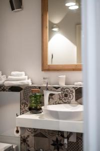 a bathroom with a white sink and a mirror at Clouds Boutique Guesthouse in Dubrovnik