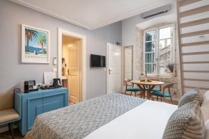 a hotel room with a bed and a table at Clouds Boutique Guesthouse in Dubrovnik