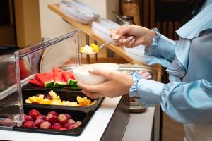 a person eating food from a plate of fruit at Ta' Tereza In Manwel Dimech in Sliema