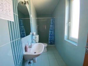 a bathroom with a sink and a toilet at PICNIC Vendégház in Bogács