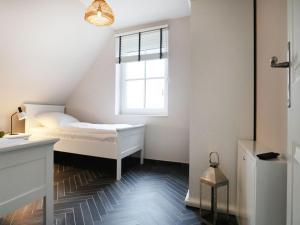 a small bedroom with a bed and a window at Jolle Ferienhaus in Groß Schwansee +15 photos
