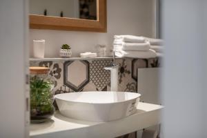 a bathroom with a white sink on a counter at Clouds Boutique Guesthouse in Dubrovnik +19 photos