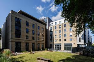 a building with a park in front of it at Unite Students - Chalmers Street - The Meadows in Edinburgh