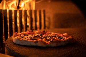 a pizza is coming out of an oven at Hotel des Alpes in Flims