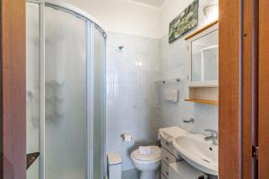 a bathroom with a shower and a toilet and a sink at Casa di Allegra Terme di Venturina - Happy Rentals in Campiglia Marittima