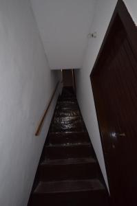 a stairway leading up to a building with a wooden door at Saraceni 20 in Cefalù