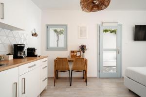 a kitchen with a table and chairs in a room at Naxos Joya Apartment in Naxos Chora