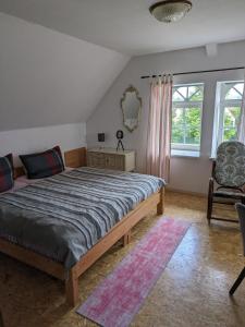 1 dormitorio con 1 cama, 1 silla y 1 ventana en Ferienhaus -Am alten Dorfplatz- en Dresden