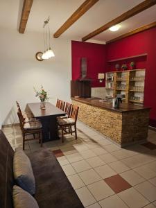 a living room with a table and a kitchen at Apartmán U Sudu in Kobylí